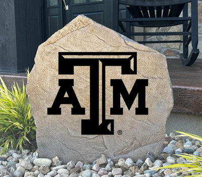 Texas A&M University logo stone placed in front yard landscaping