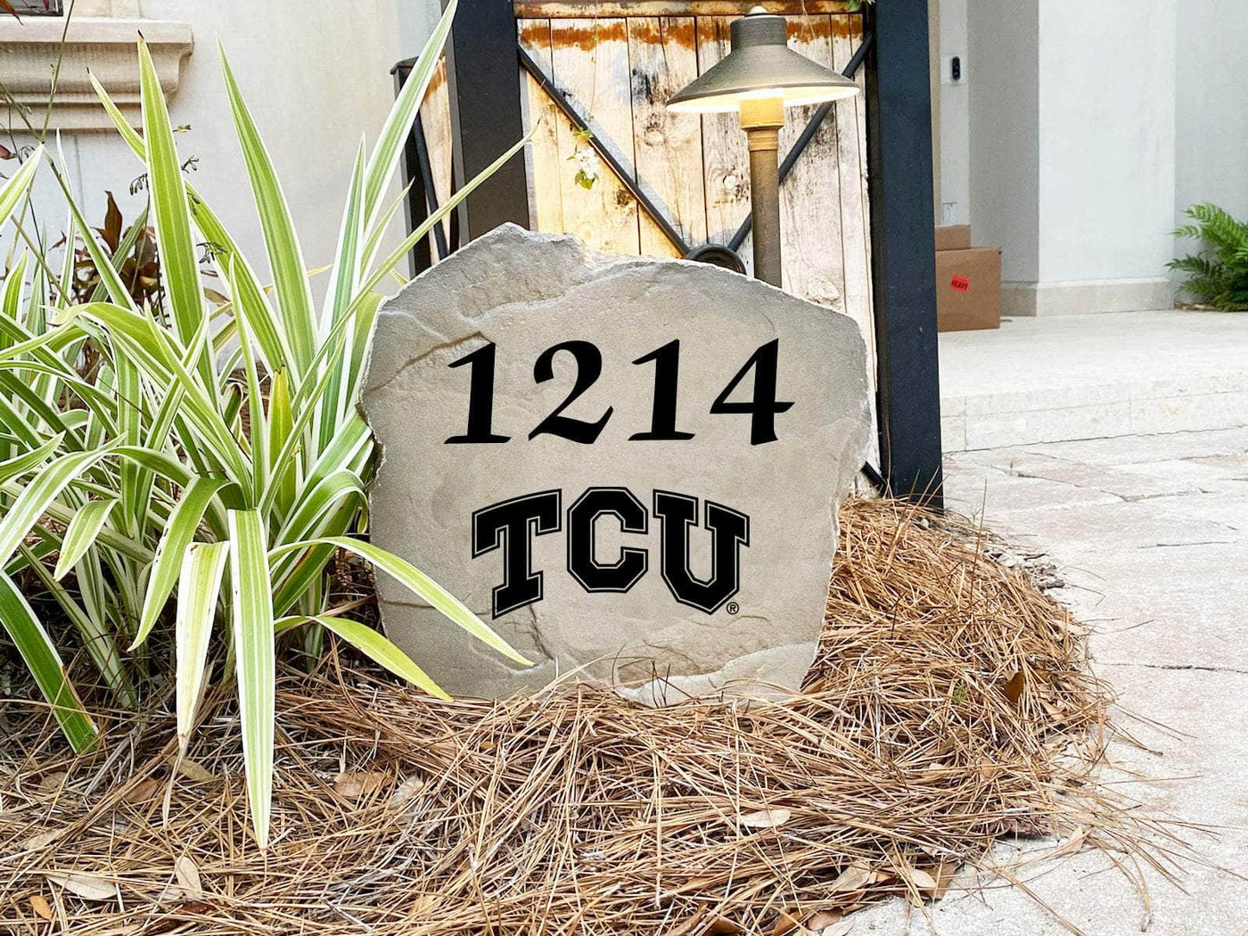 Custom Texas Christian University address rock displayed in a landscaped yard