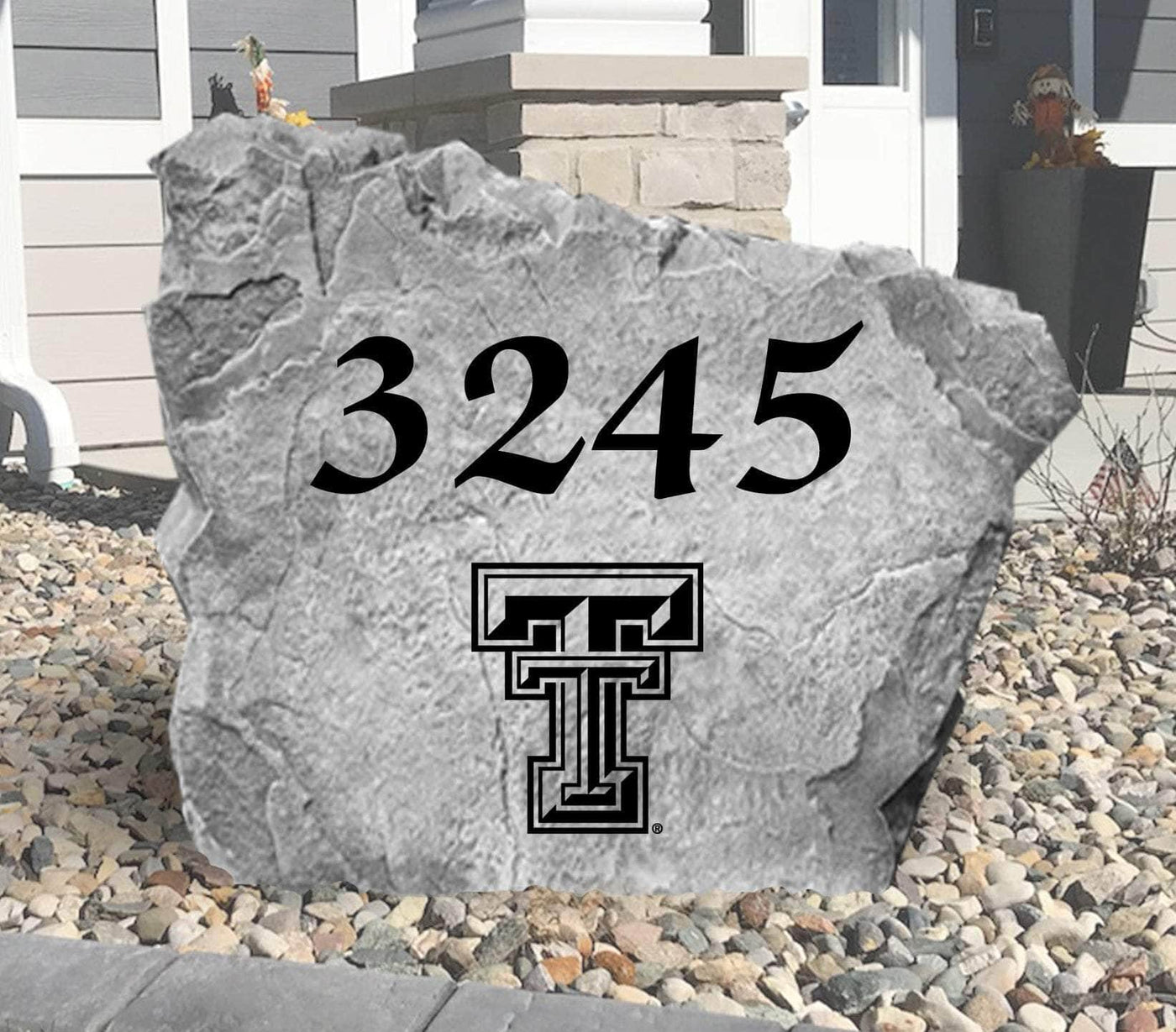 Custom landscaping stone featuring Texas Tech logo and house number