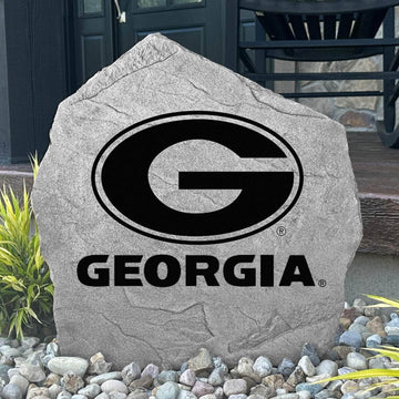 Custom Georgia Bulldogs Logo Stone displayed in a landscaped flower bed, showcasing officially licensed team artwork permanently engraved into the stone. This outdoor accent creates a beautiful focal point for alumni homes and devoted Bulldogs fans.