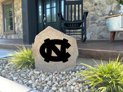 Outdoor decorative stone engraved with University of North Carolina emblem