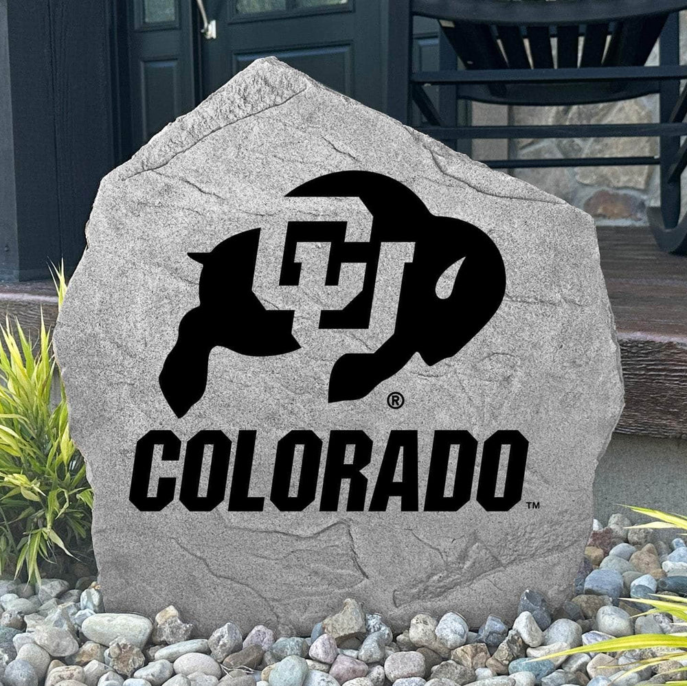 Custom Colorado Buffaloes Logo Stone displayed in a landscaped flower bed, showcasing officially licensed team artwork permanently engraved into the stone. This outdoor accent creates a beautiful focal point for alumni homes and devoted Buffaloes fans.