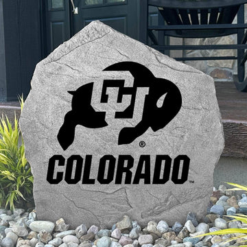 Custom Colorado Buffaloes Logo Stone displayed in a landscaped flower bed, showcasing officially licensed team artwork permanently engraved into the stone. This outdoor accent creates a beautiful focal point for alumni homes and devoted Buffaloes fans.
