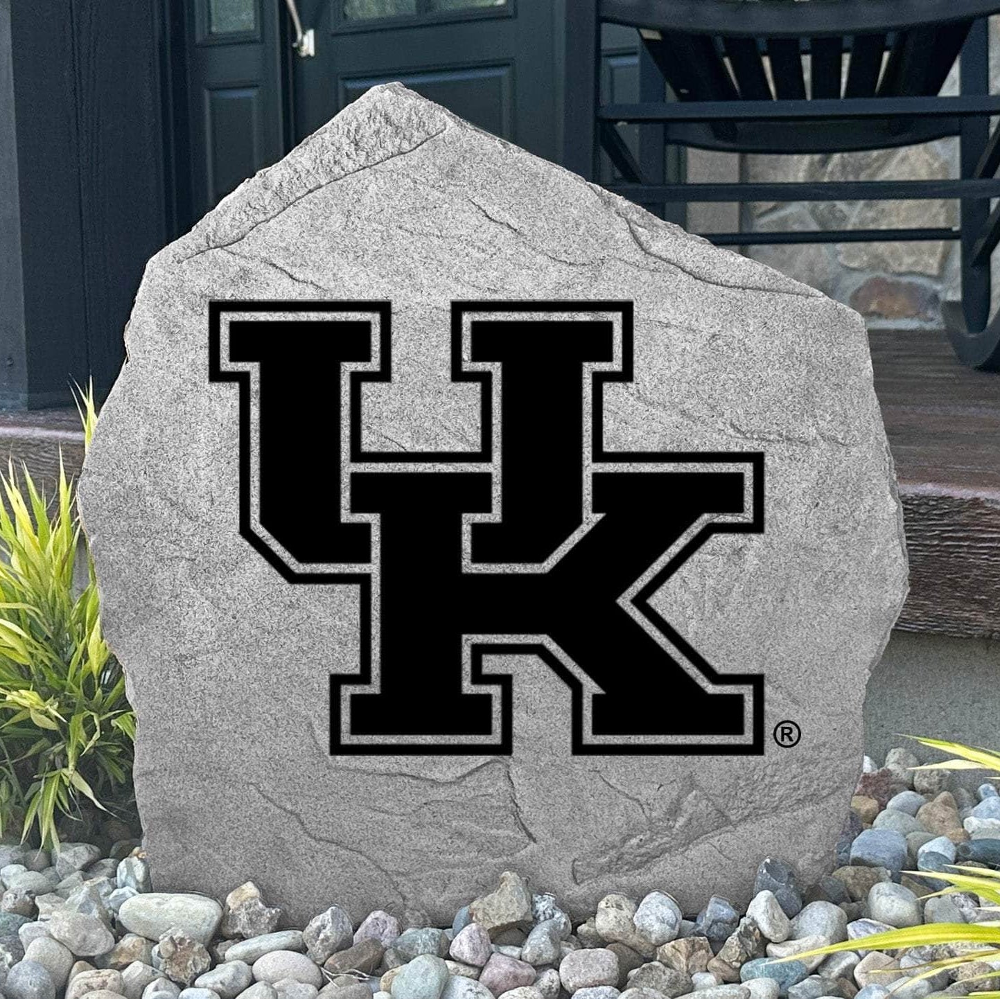 Custom Kentucky Wildcats Logo Stone displayed in a landscaped flower bed, showcasing officially licensed team artwork permanently engraved into the stone. This outdoor accent creates a beautiful focal point for alumni homes and devoted Wildcats fans.