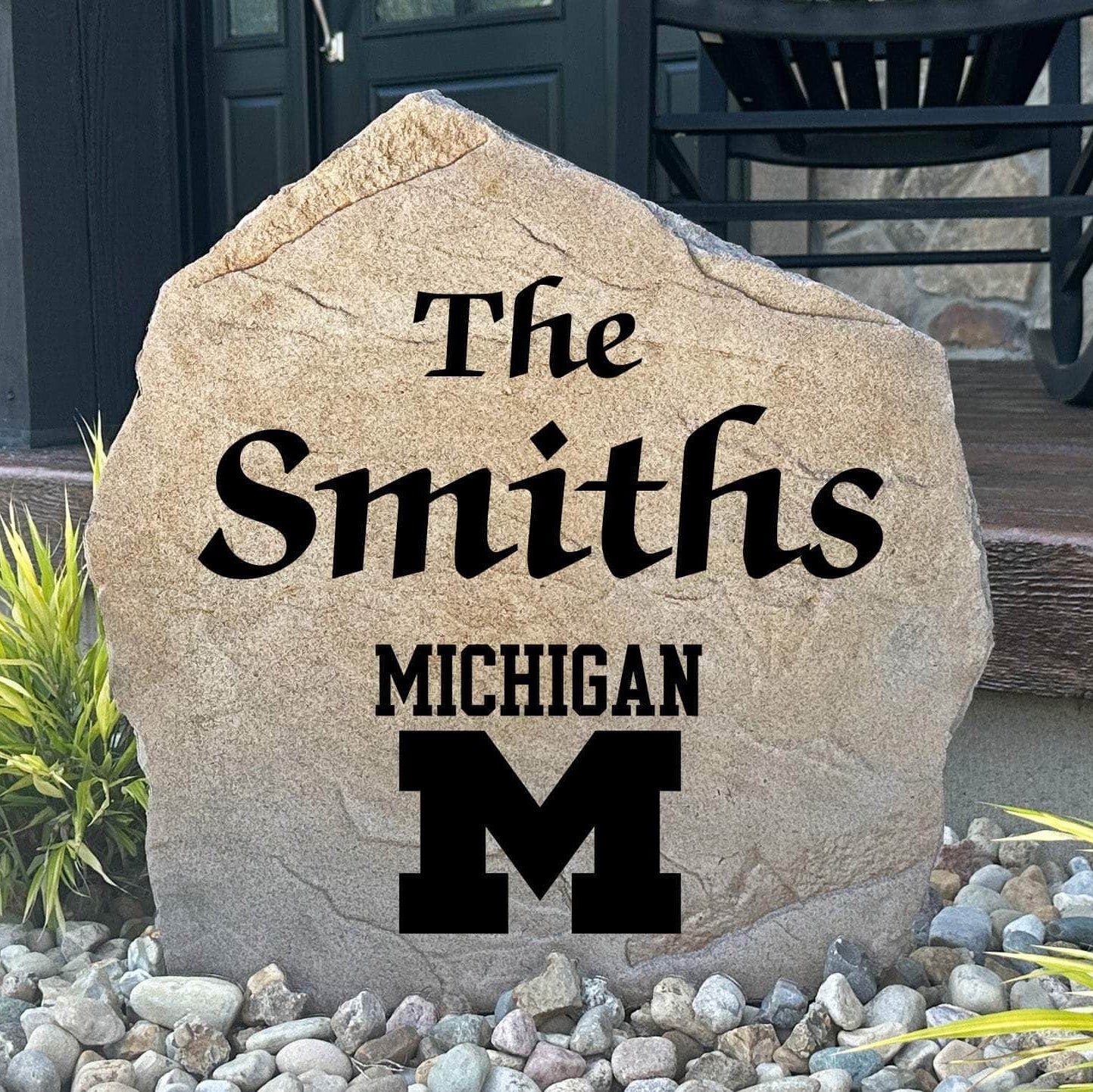 Officially licensed University of Michigan Name Stone featuring a personalized family name and the iconic Michigan Wolverines logo engraved directly into the stone surface. This custom garden stone adds school pride and curb appeal to front yards, patios, gardens, and entryways.