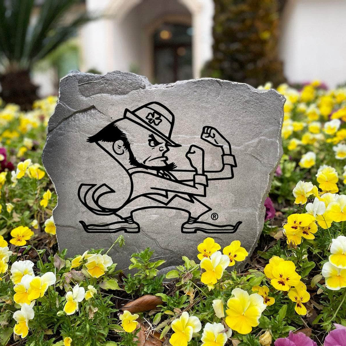 Officially licensed Notre Dame Leprechaun Stone handcrafted in the USA with detailed mascot engraving and durable construction. This decorative garden stone enhances landscape beds and outdoor spaces with lasting beauty and school spirit.