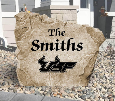 Engraved University of South Florida Bulls logo with family name on landscaping stone