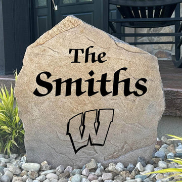 Officially licensed University of Wisconsin Name Stone featuring a personalized family name and the iconic Wisconsin Badgers logo engraved directly into the stone surface. This custom engraved garden stone adds school pride and curb appeal to front yards, patios, gardens, and entryways.