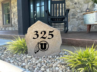 Outdoor engraved stone with University of Utah logo and home number.