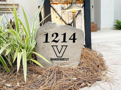 Engraved concrete stone displaying Vanderbilt house number and emblem