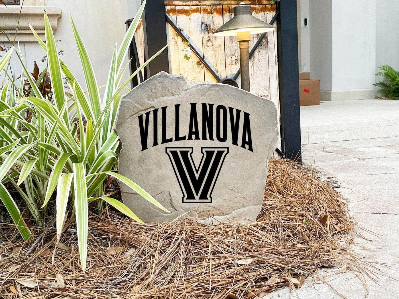 Outdoor landscaping rock featuring engraved Villanova logo