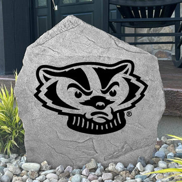 Custom Wisconsin Badger Stone displayed in a landscaped flower bed, showcasing officially licensed Bucky Badger artwork with permanent engraving. This decorative outdoor stone creates a bold focal point for alumni homes and Wisconsin fans.