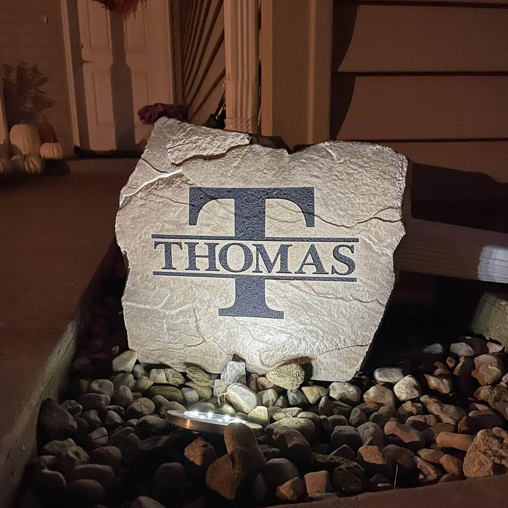 Weather-resistant solar-powered landscape spotlight providing automatic dusk-to-dawn illumination for engraved stones, flower beds, and yard décor.