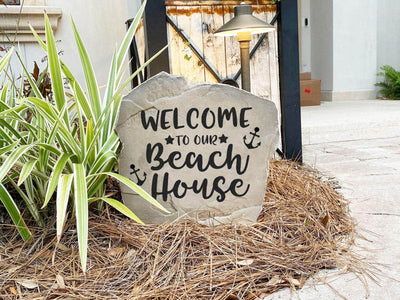 Coastal rock engraved with welcome to our beach house design