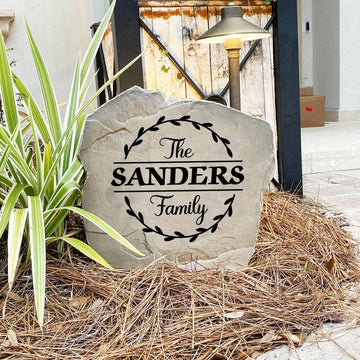 Decorative engraved family surname stone surrounded by graceful vine artwork, perfect for enhancing curb appeal with personalized style.