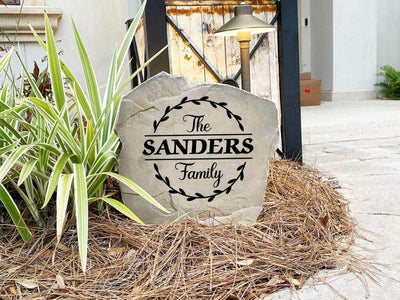 Custom outdoor stone with family name and decorative vine border