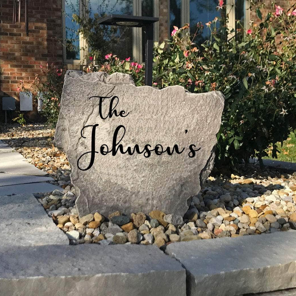 Decorative script surname landscape stone showcasing graceful engraved lettering that enhances curb appeal with a sophisticated outdoor accent.