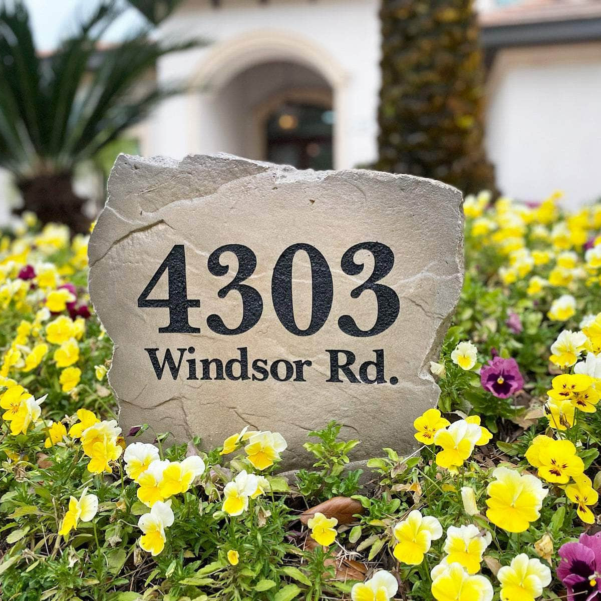 Handcrafted engraved address monument combining premium concrete craftsmanship with personalized home identification for a polished residential landscape.