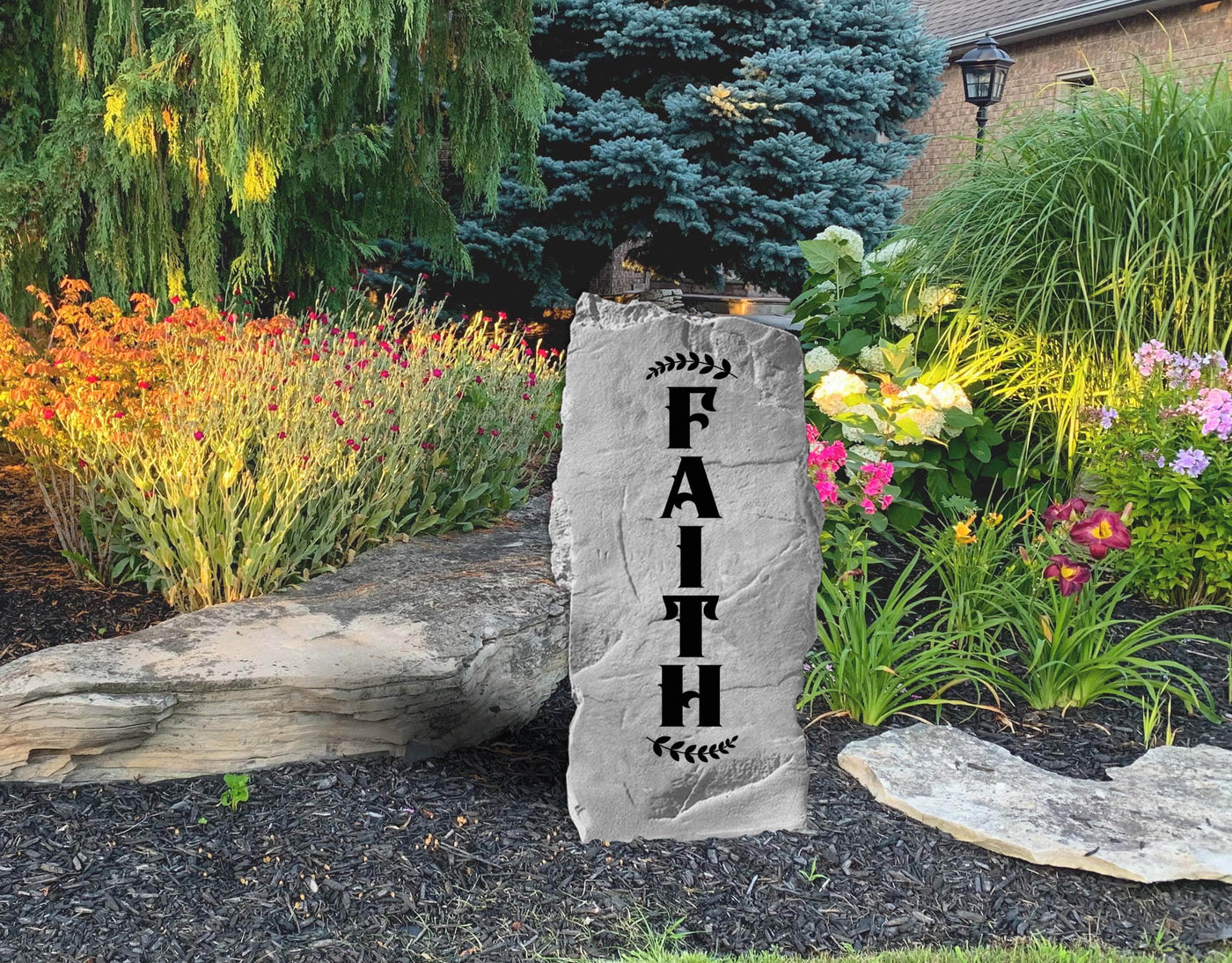 Engraved garden stone displaying Faith in rustic style