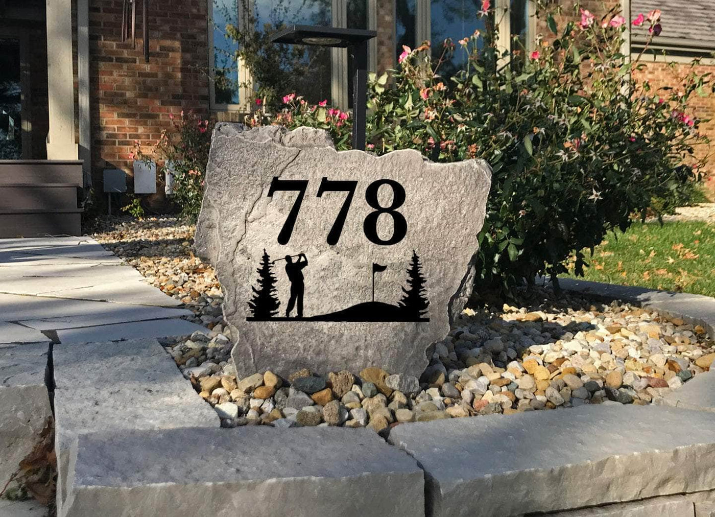 Engraved stone with golf design and address for outdoor garden