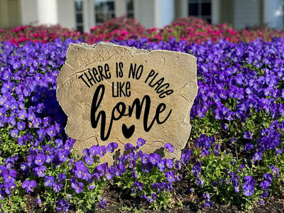 Monument-grade engraved rock featuring “There is no place like home.”