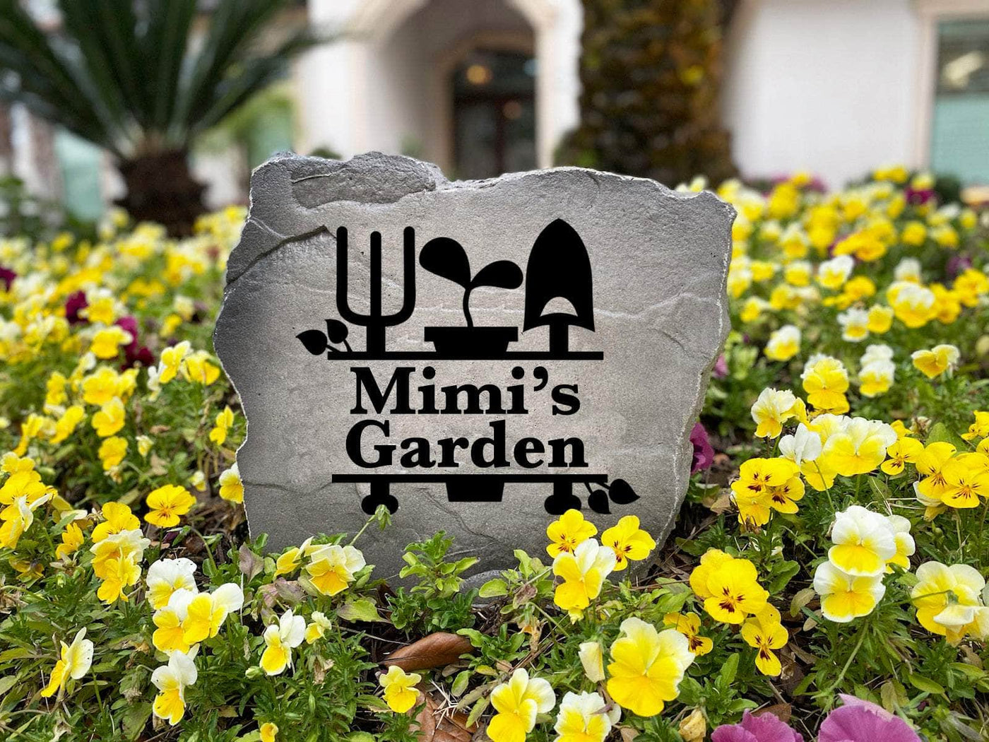 Custom garden monogram rock with engraving and leaf illustration.