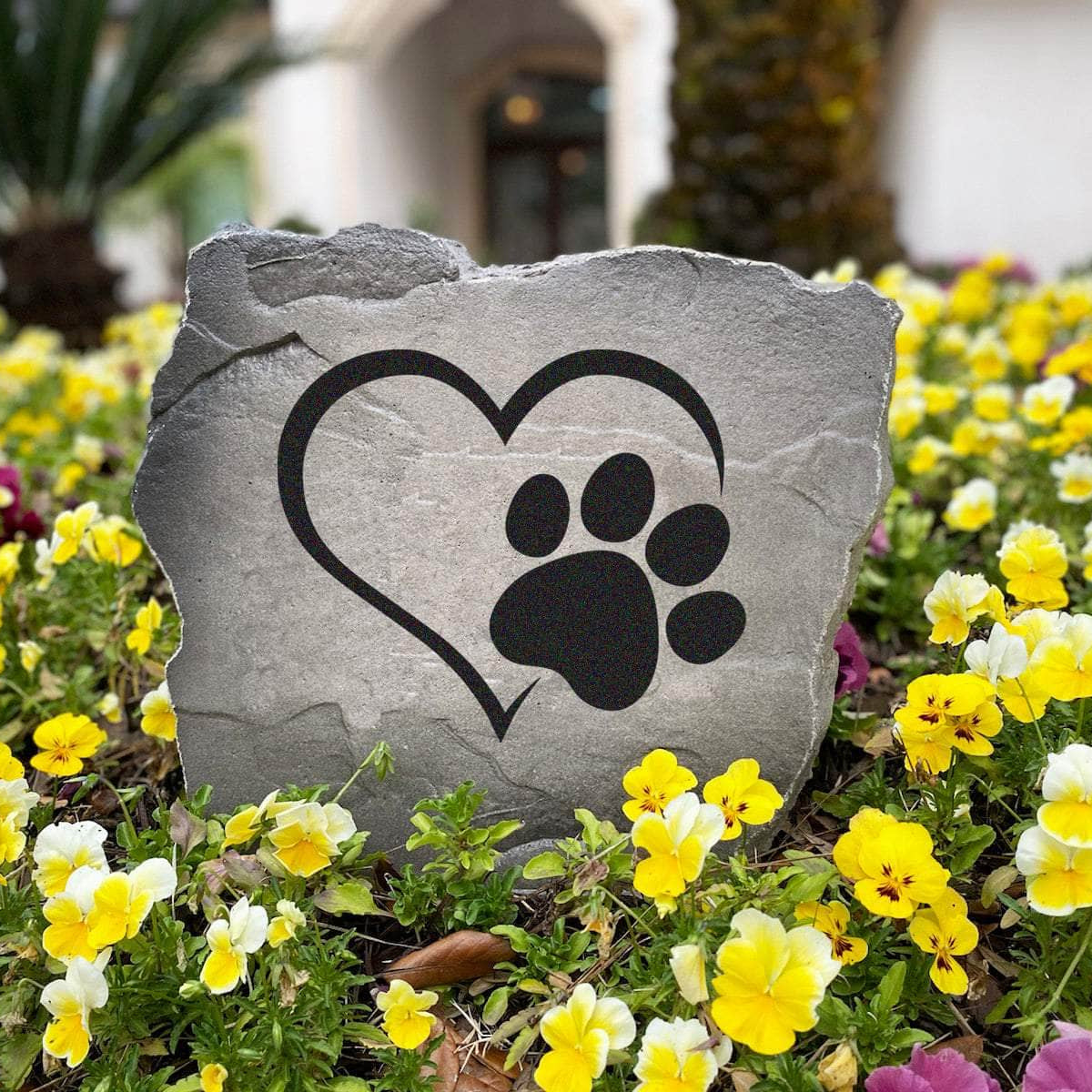 Pet-inspired outdoor stone featuring a heart and paw print design, perfect for gardens, walkways, patios, and backyard retreats.