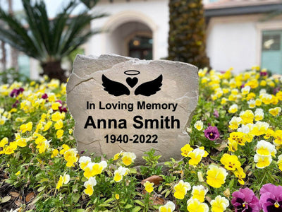 In Loving Memory stone marker with angel wings and halo.