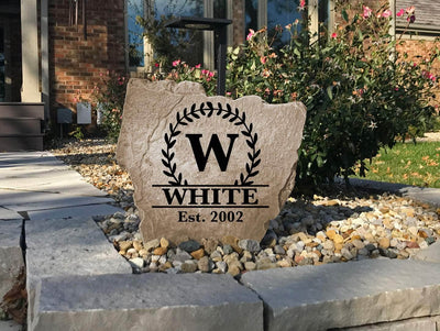 Engraved family stone featuring vine monogram design with established date