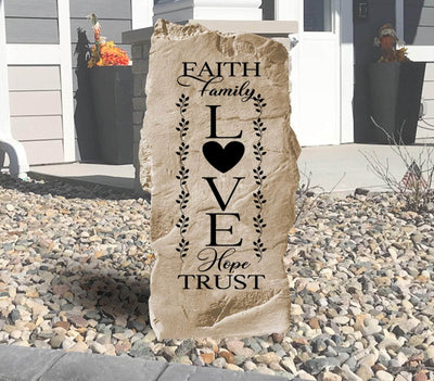 Engraved stone featuring Faith Family Love inspirational message