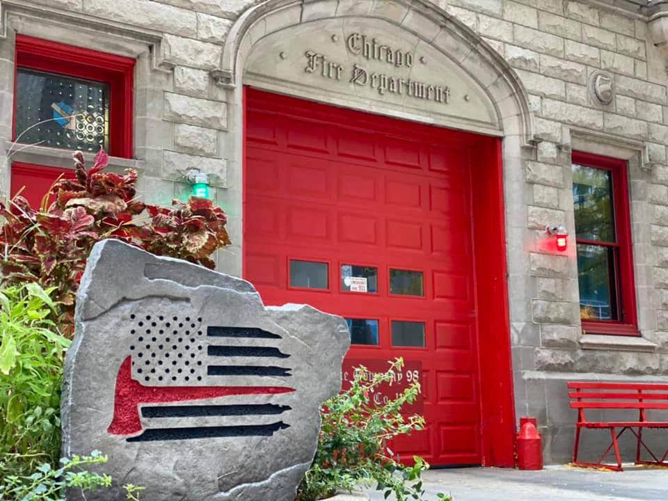 Engraved stone honoring firefighters with American flag engraving