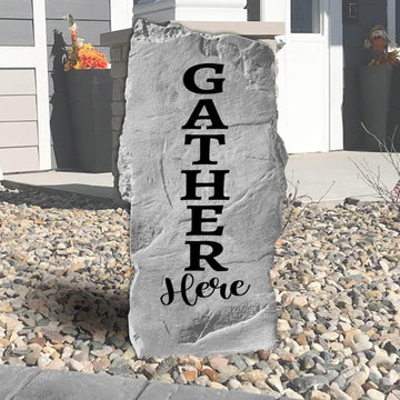 Gather Here engraved landscape stone inviting family and friends to enjoy meaningful moments in beautifully designed outdoor living spaces.