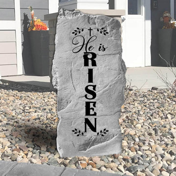 He Is Risen engraved garden stone celebrating the resurrection of Jesus Christ with a meaningful outdoor display of Christian faith and hope.