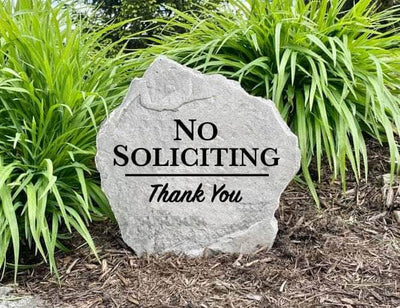 Decorative engraved rock for entryway with No Soliciting sign