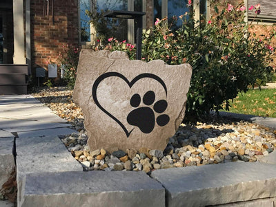 Durable garden rock with heart paw print engraving for pet lovers