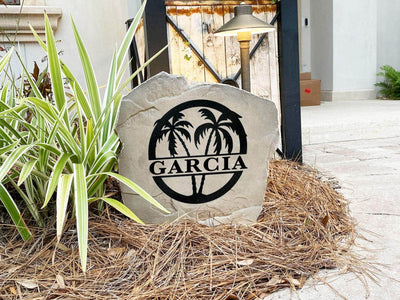 Palm tree family monogram stone used as decorative landscaping marker