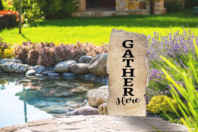 Decorative landscaping stone saying Gather Here for home entry