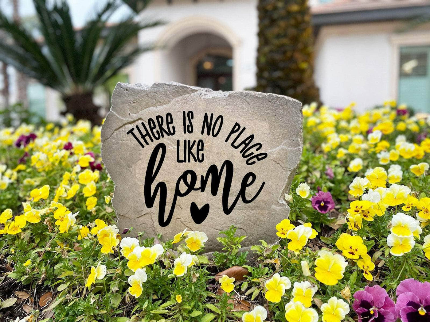 Personalized garden rock engraved with “There is no place like home.”