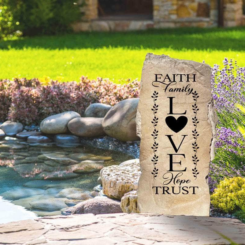 Decorative Christian family landscape stone featuring the uplifting message "Faith Family Love," perfect for creating a welcoming outdoor retreat.