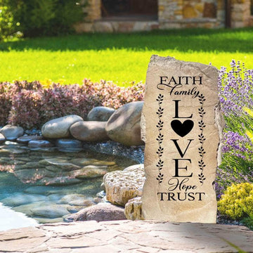 Decorative Christian family landscape stone featuring the uplifting message "Faith Family Love," perfect for creating a welcoming outdoor retreat.