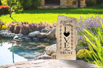Outdoor concrete stone engraved with Faith Family Love words