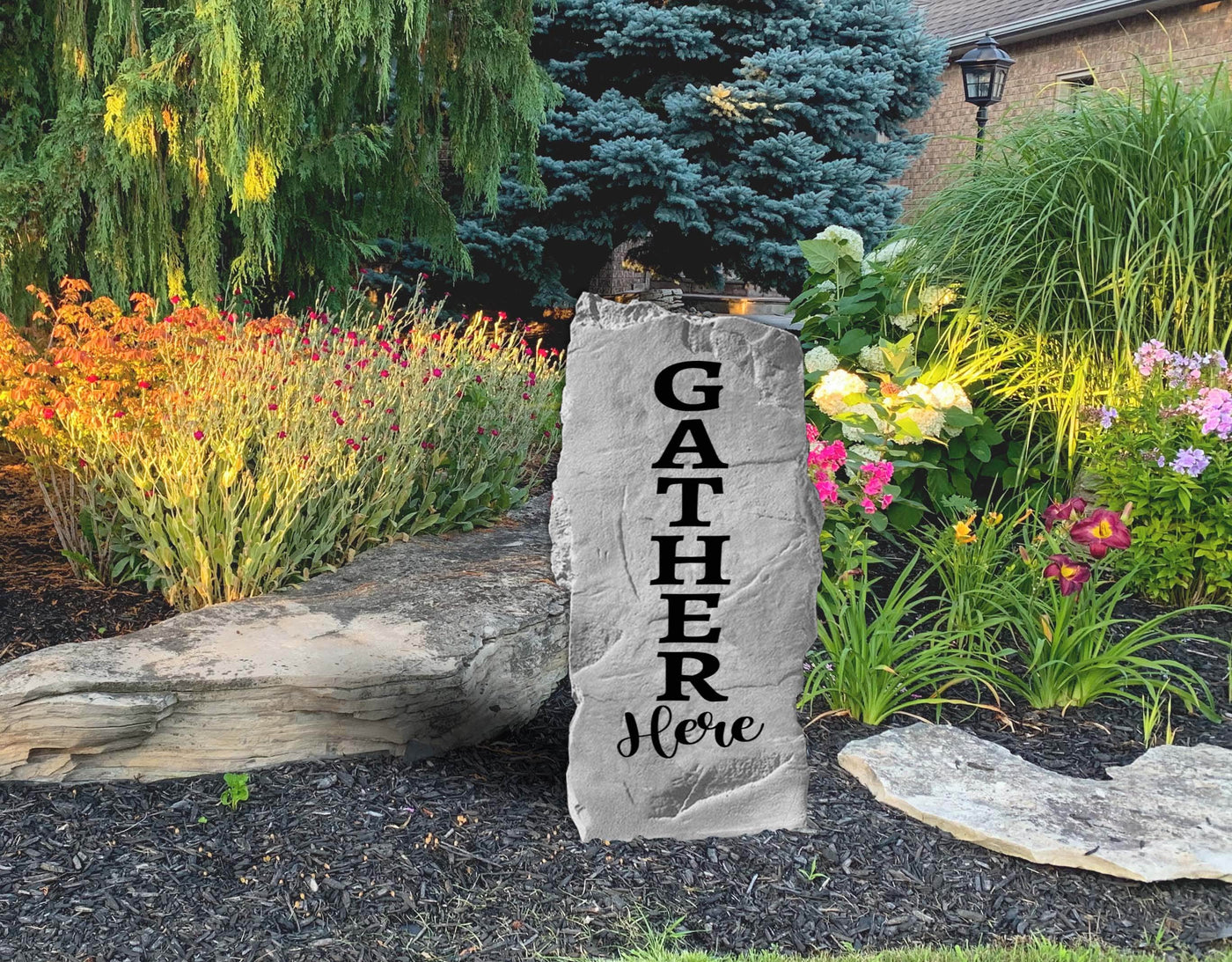 Rustic garden rock engraved with Gather Here phrase