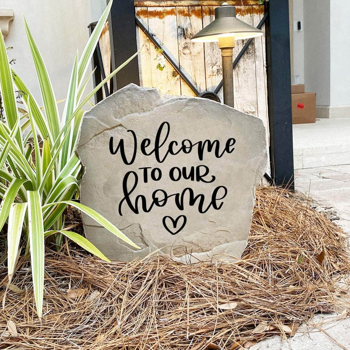 Elegant outdoor welcome plaque displaying "Welcome To Our Home" with a heart motif, perfect for enhancing curb appeal and greeting guests.