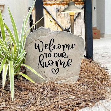 Elegant outdoor welcome plaque displaying "Welcome To Our Home" with a heart motif, perfect for enhancing curb appeal and greeting guests.